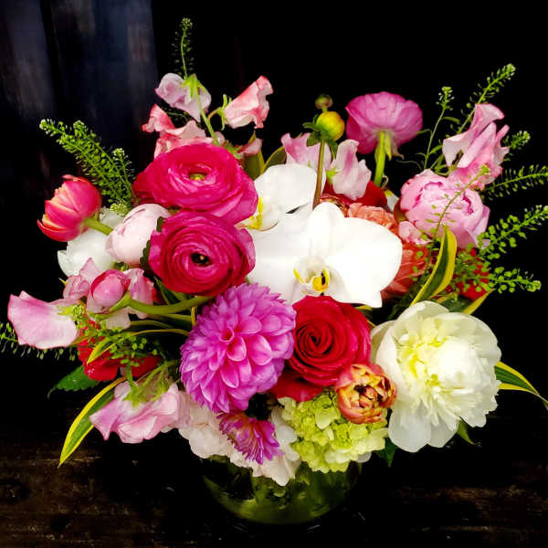 Mixed pink and white floral arrangement in a glass vase