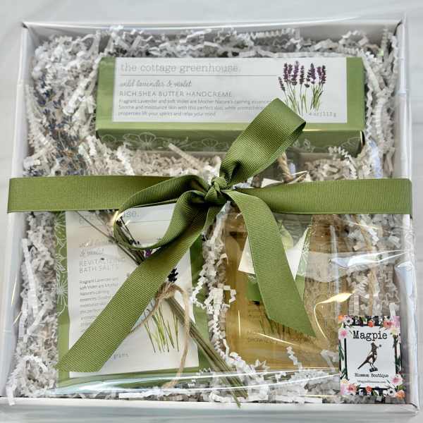 Gift box with lavender bath products tied with a green ribbon