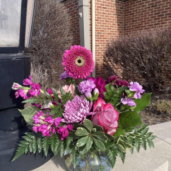 Pink and purple bouquet in a glass vase