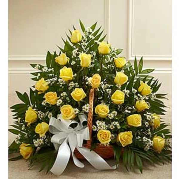 Basket arrangement of yellow roses with a white ribbon bow