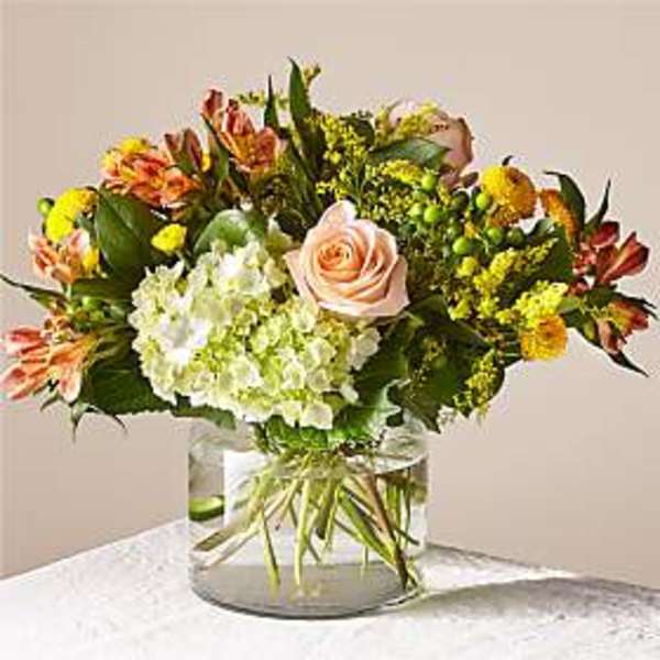 Mixed bouquet with a pale pink rose and white hydrangea in a glass vase