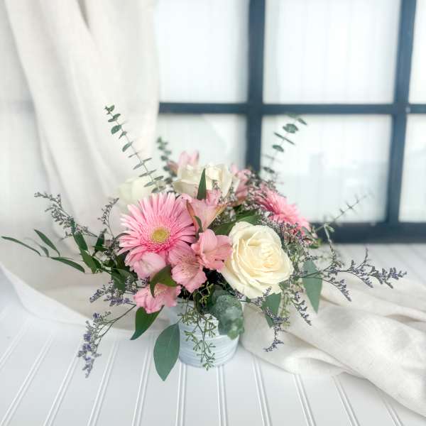Pink and white bouquet in a small white vase