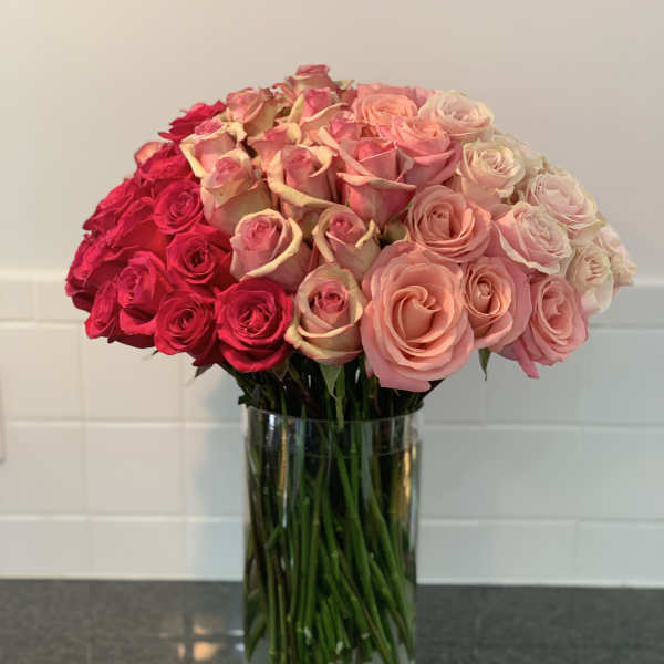 Bouquet of pink and red roses in a clear glass vase