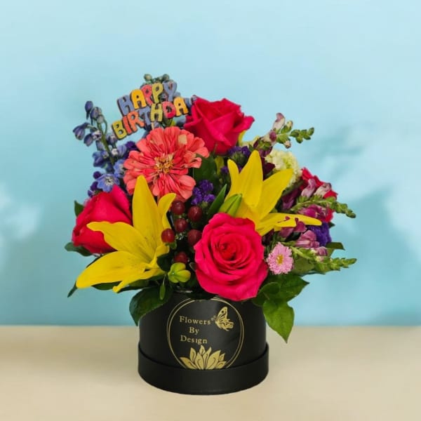 Birthday flower arrangement in a black box with roses and lilies