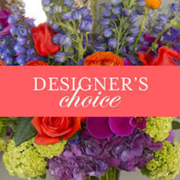 Mixed bouquet with red roses and purple flowers, labeled designer's choice