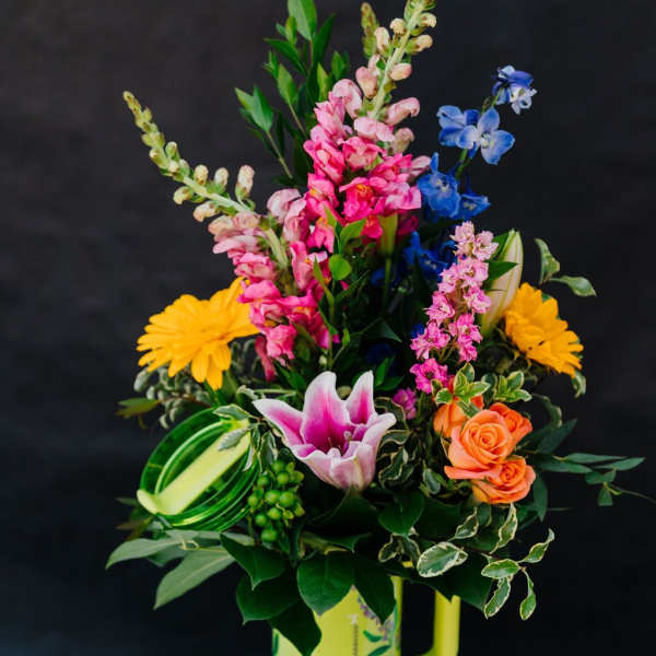 Colorful mixed bouquet in a yellow handled vase