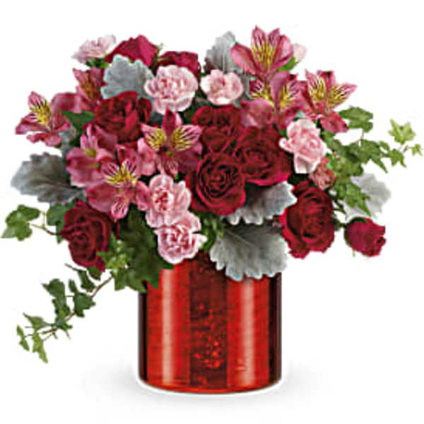 Bouquet of red roses and pink alstroemeria in a red vase