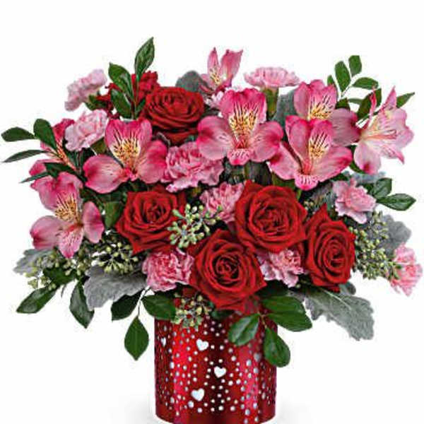 Red roses and pink alstroemeria in a red heart-patterned vase