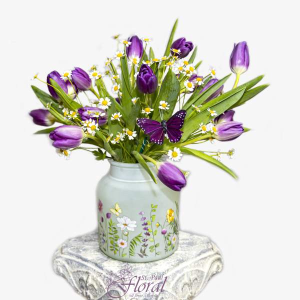Purple tulips and white daisies in a painted vase with a butterfly decoration