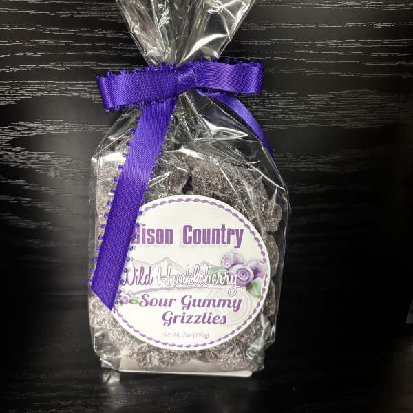 Bag of sour gummy grizzlies tied with a purple ribbon