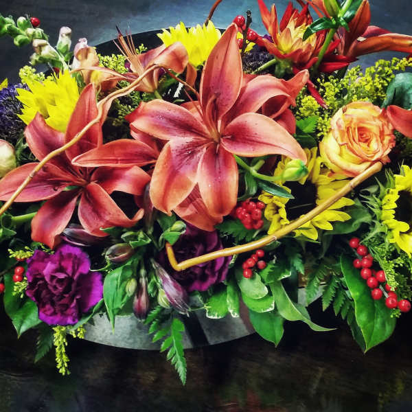 Mixed bouquet with lilies, roses, sunflowers, and purple blooms