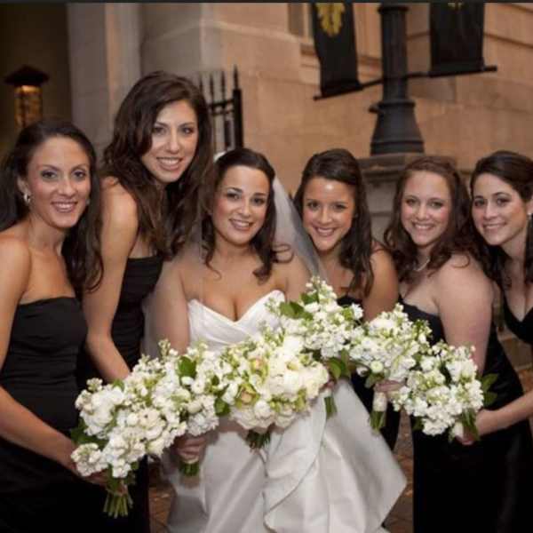 Bride and bridesmaids holding white bouquets