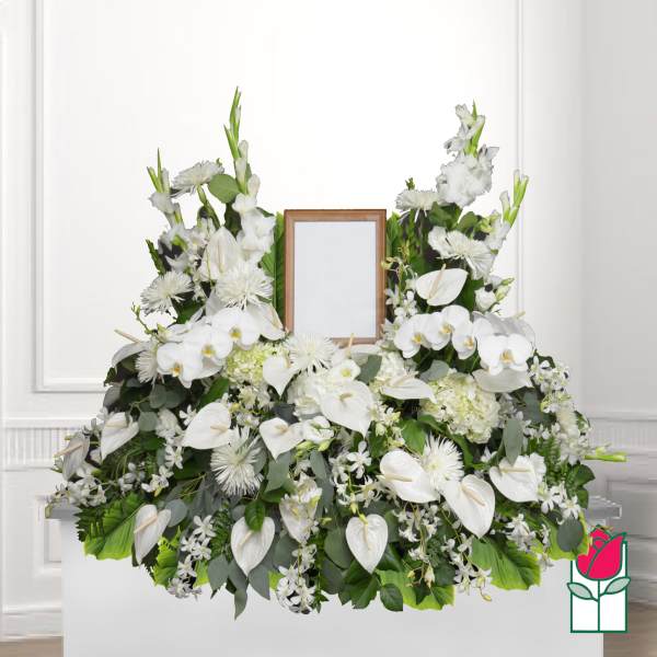White floral funeral spray with a framed photo holder in the center