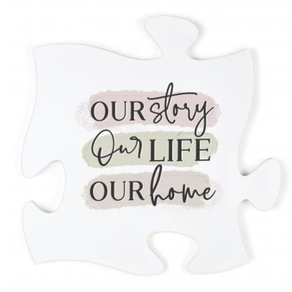 White puzzle piece sign with the words "Our story Our life Our home"