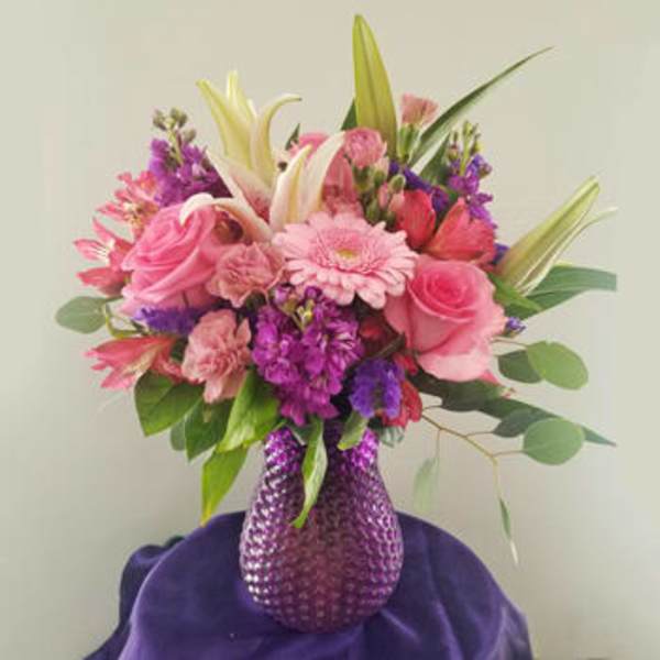 Pink and purple mixed bouquet in a textured purple vase