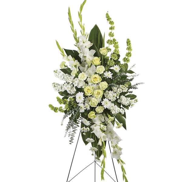 Tall white and pale green floral standing spray on an easel