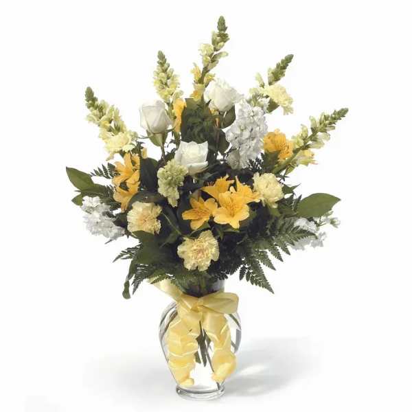 Yellow and white floral arrangement in a clear glass vase with a ribbon