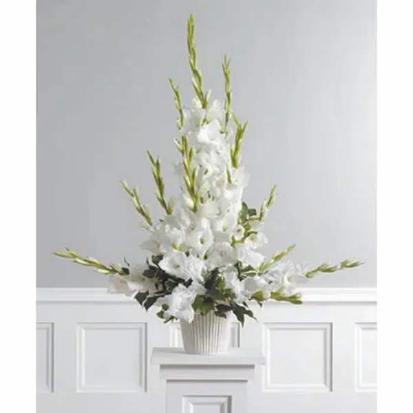 Tall white floral arrangement in a ribbed vase