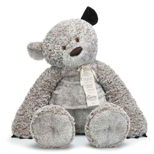 Plush teddy bear with a ribbon tag, seated on a white background