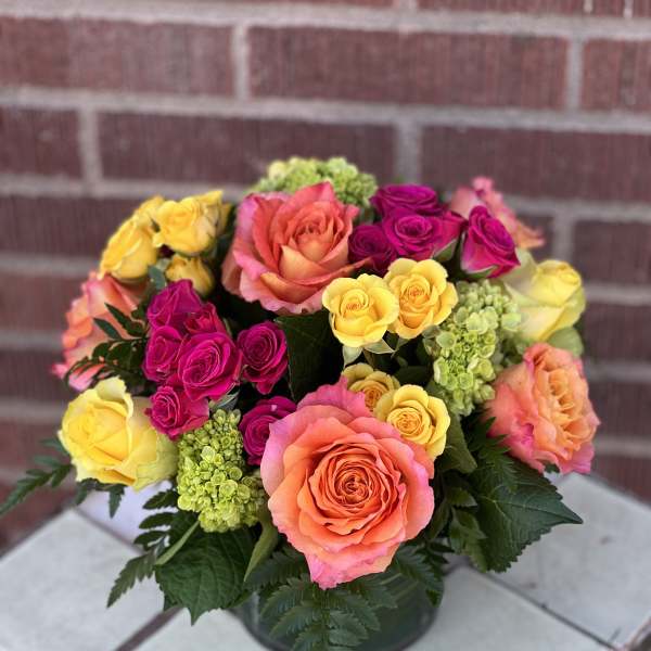 Colorful bouquet of roses in a low vase