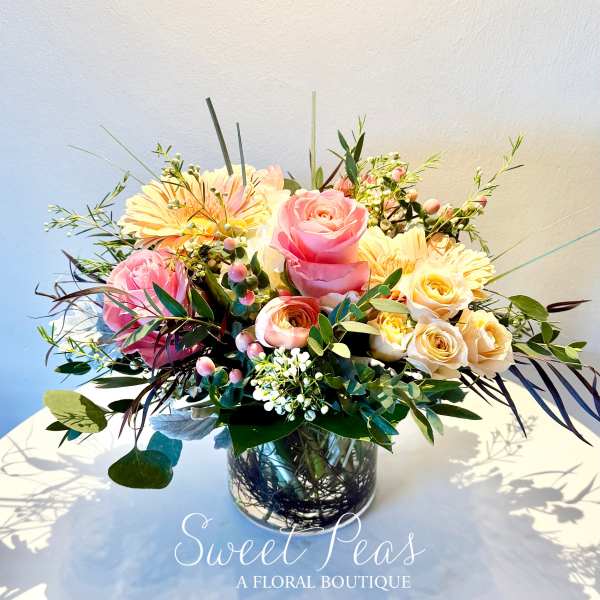 Pink and cream rose bouquet in a glass vase