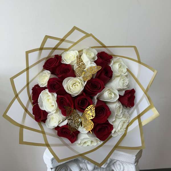 Bouquet of red and white roses with gold butterfly accents
