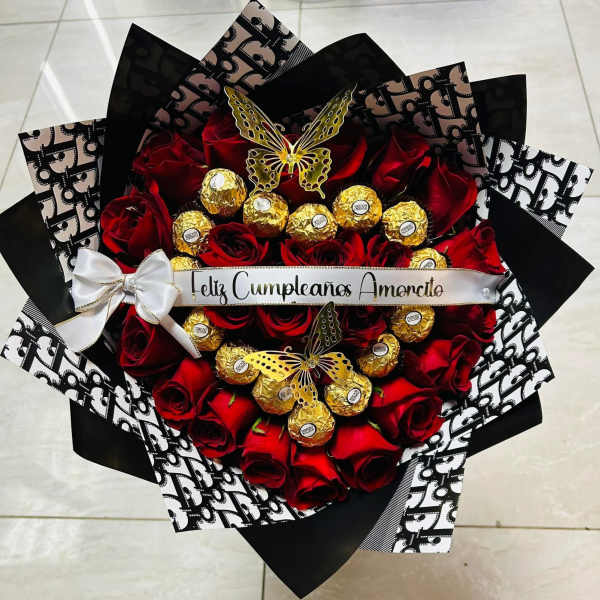 Bouquet of red roses with gold-wrapped chocolates and a white ribbon