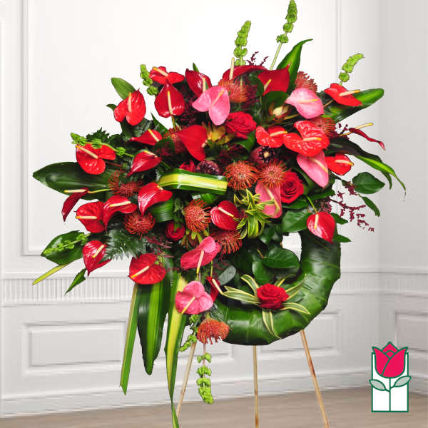 Large tropical arrangement with red and pink anthuriums and roses