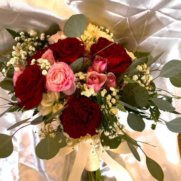 Bouquet of red and pink roses with baby's breath and eucalyptus