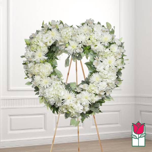 White floral heart wreath on a gold easel stand