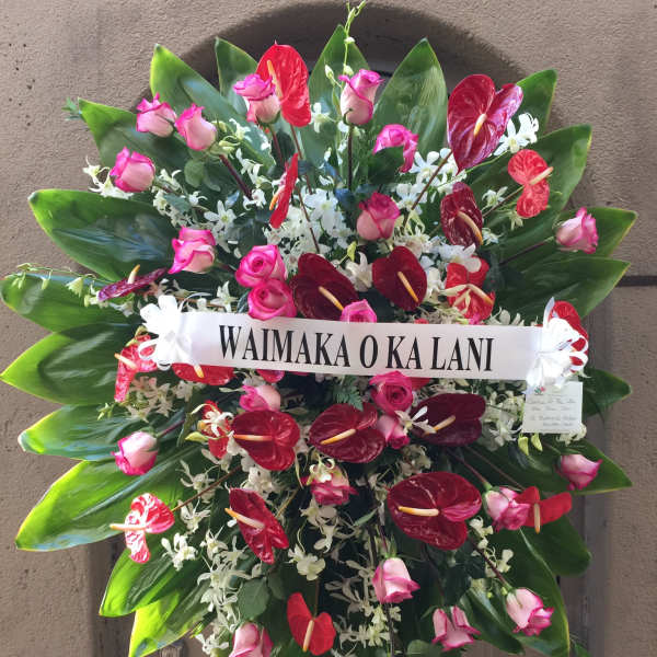 Large standing floral spray with pink roses and red anthuriums