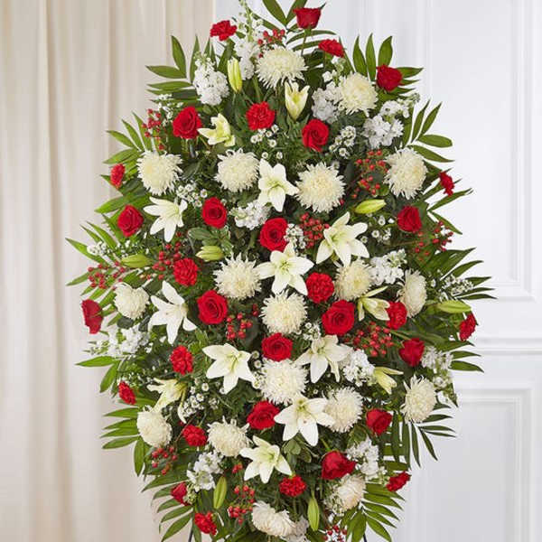 Standing floral spray with red roses, white lilies, and white chrysanthemums