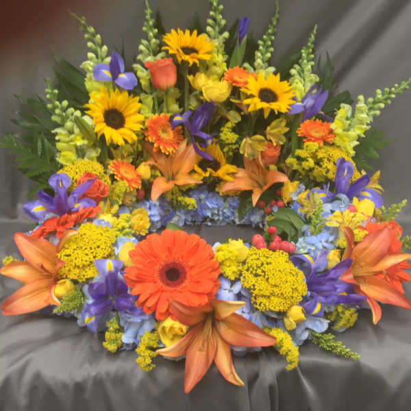 Colorful floral wreath with sunflowers, gerbera daisies, and lilies