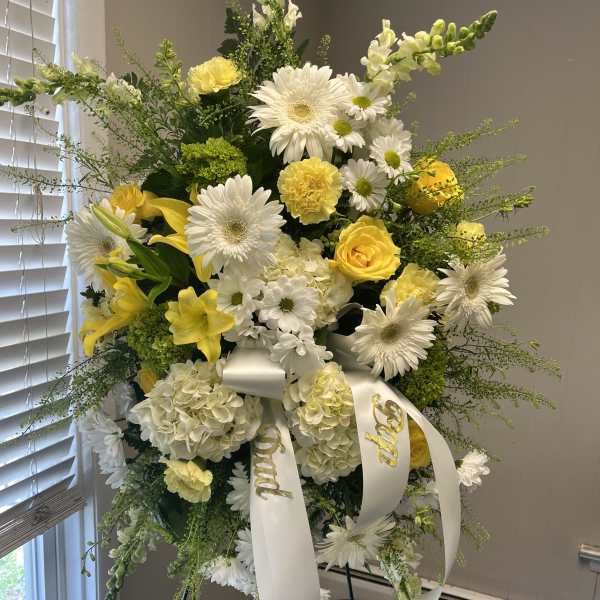 Tall white and yellow floral standing spray with ribbon