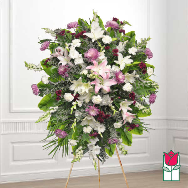 Large standing spray of white and pink flowers on an easel
