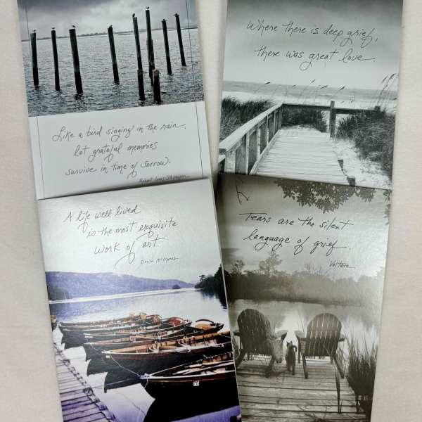 Four sympathy cards with grayscale lake and dock scenes and grief quotes