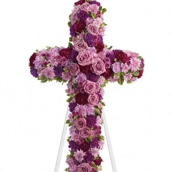 Purple and pink floral cross on a white stand