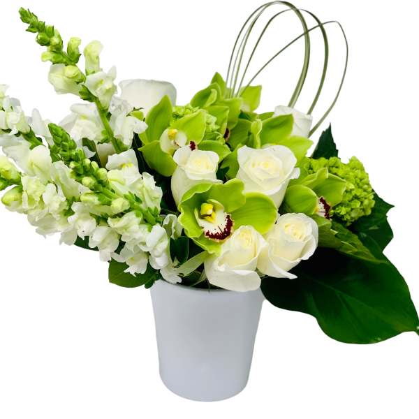 White and green floral arrangement in a white vase