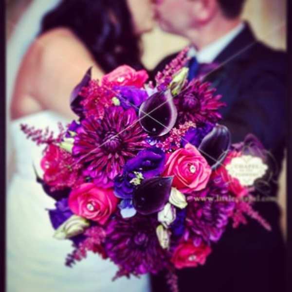 Bright pink and purple bridal bouquet with roses and dark calla lilies