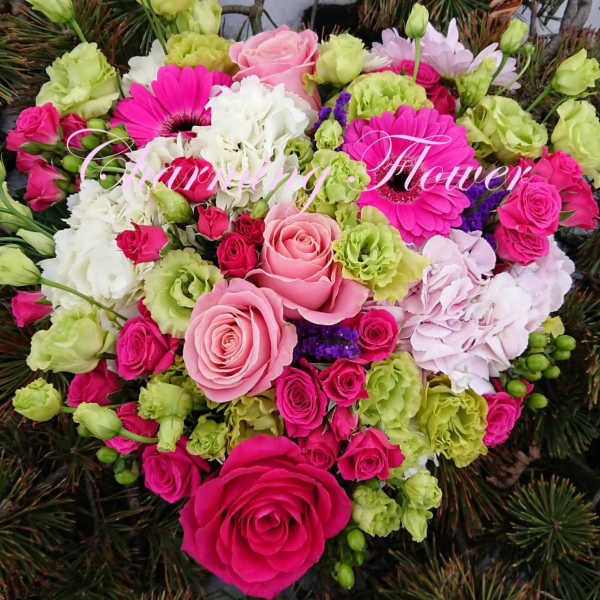 Heart-shaped bouquet of pink, white, and green flowers