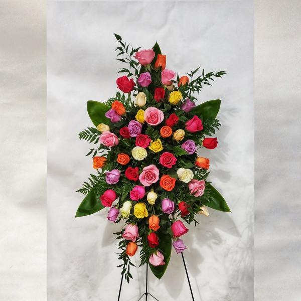 Tall standing spray of multicolored roses on an easel