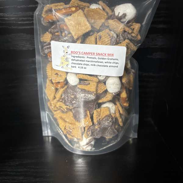 Clear bag of camper snack mix with pretzels, cereal, marshmallows, and chocolate pieces