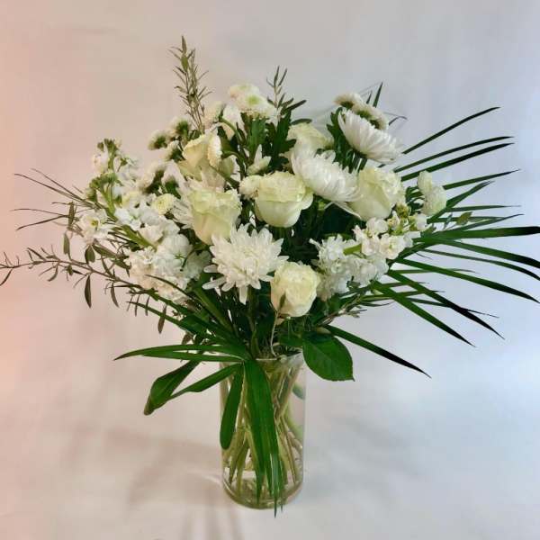 White floral arrangement in a clear glass vase