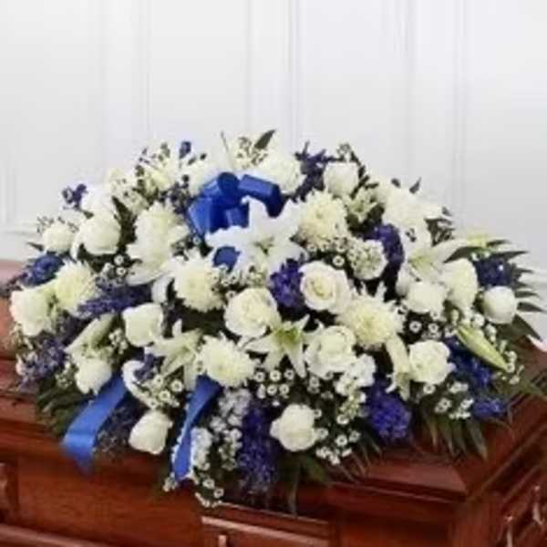 White and blue funeral spray on a casket