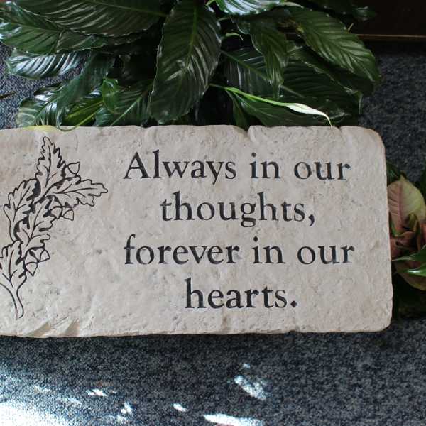 Memorial stone engraved with "Always in our thoughts, forever in our hearts."