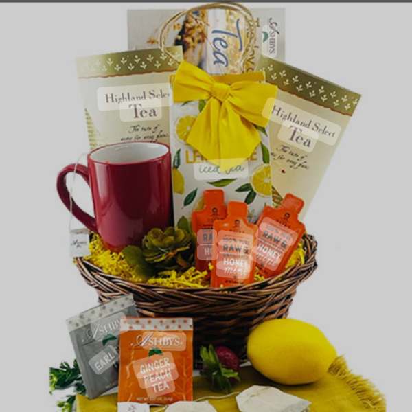 Gift basket with tea packets, honey bottles, a mug, and a lemon plush