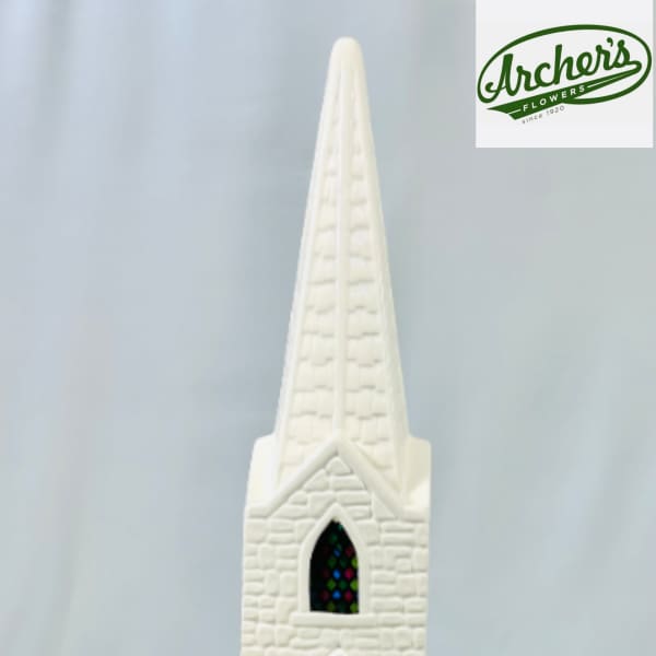 White church figurine with a tall steeple and stained-glass windows