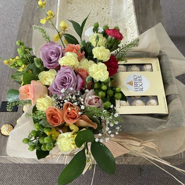 Mixed bouquet of roses and carnations with a Ferrero Rocher box