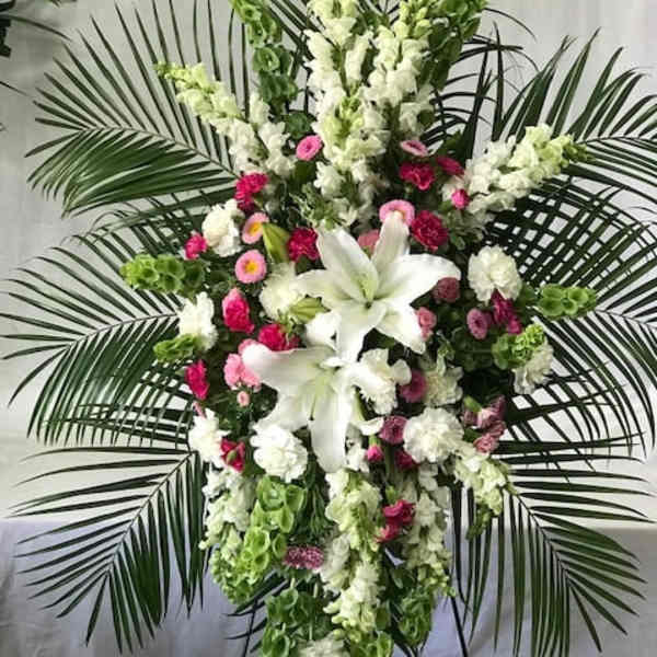 Tall standing floral spray with white lilies and pink flowers