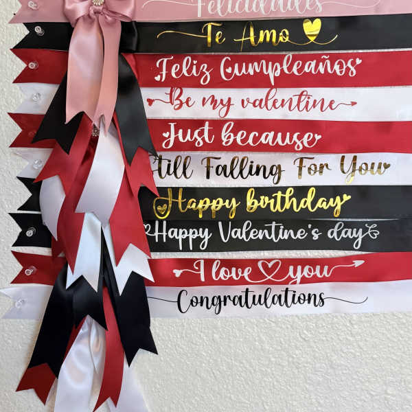 Decorative ribbon banner with assorted greeting text and a pink bow